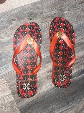 Tory Burch Orange and Black Logo Pattern Flip Flops
